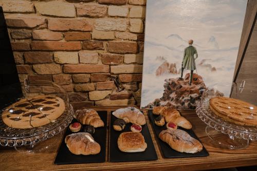 a table topped with different types of pastries and pies at B&B Civico 35 in Chieti