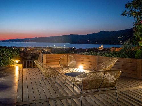 a deck with chairs and a view of the water at Résidence U Frusteru in Propriano