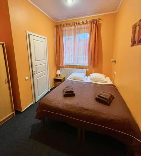 a bedroom with a bed with two towels on it at Jeruzale Hotel in Vilnius