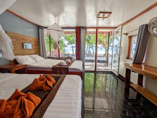 una camera d'albergo con due letti e una finestra di Pura Vita Resort a Koh Rong Island