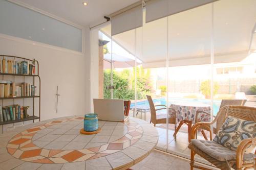 a living room with a table with a laptop on it at Magnifica Villa tranquila con piscina in Alcudia