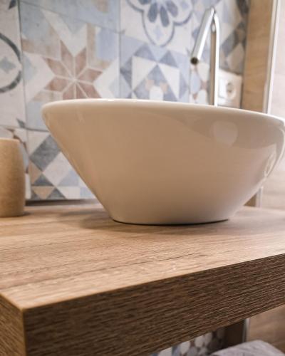 a white bowl sitting on top of a wooden counter at B&B Civico 35 in Chieti