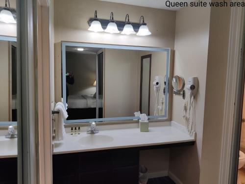 a bathroom with a sink and a mirror at Hawthorn Extended Stay by Wyndham Dayton in Dayton