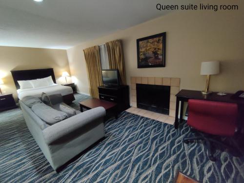 a hotel room with a couch and a bed and a fireplace at Hawthorn Extended Stay by Wyndham Dayton in Dayton