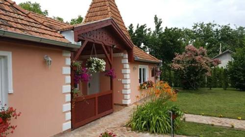 a house with a porch with flowers on it at Villa Sunset in Palić