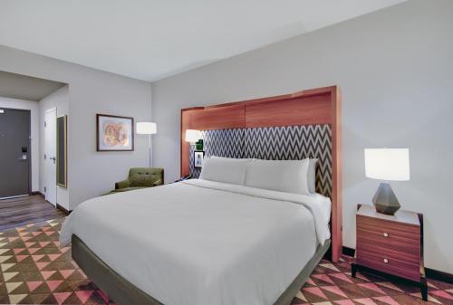 a large white bed in a hotel room at Holiday Inn - Erie by IHG in Erie
