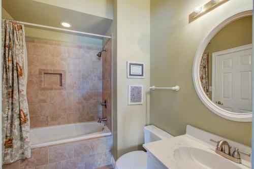a bathroom with a sink and a toilet and a tub at Sweet Trade in Holden Beach