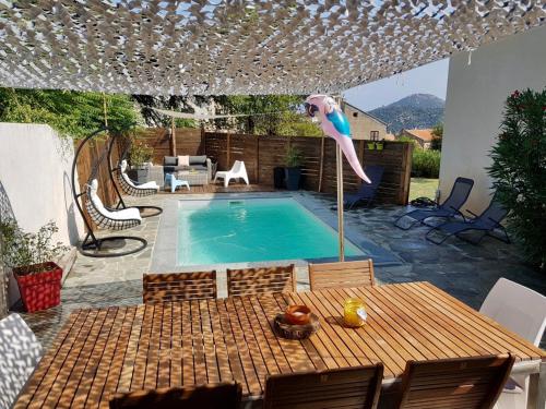 a person jumping into a swimming pool at VILLA CHJOSELLA 150M2 PISCINE ET AU CALME in Santa-Reparata-di-Balagna