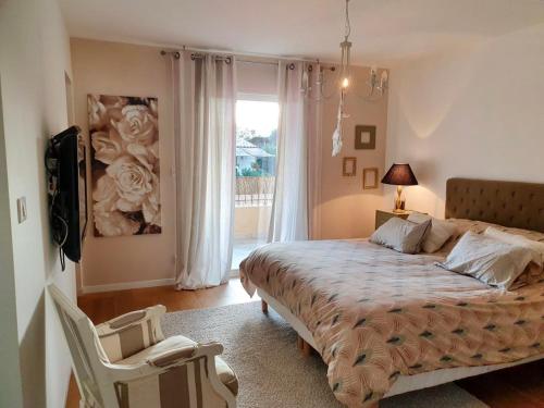 a bedroom with a large bed and a window at VILLA CHJOSELLA 150M2 PISCINE ET AU CALME in Santa-Reparata-di-Balagna