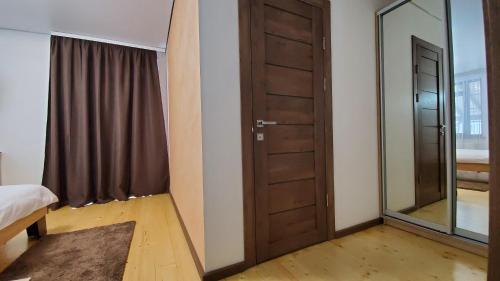 a bedroom with a door and a mirror at SPA Resort Villa Sofia in Yablunytsya
