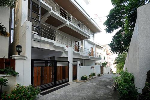 an apartment building with a gate and a balcony at Bluewaves Westcliff Villa in Boracay