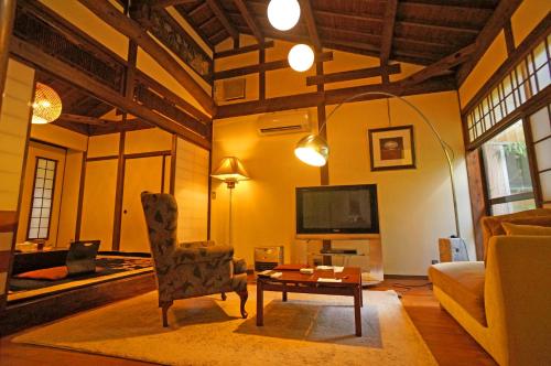 a living room with a couch and a table at Mujinzo in Yufuin