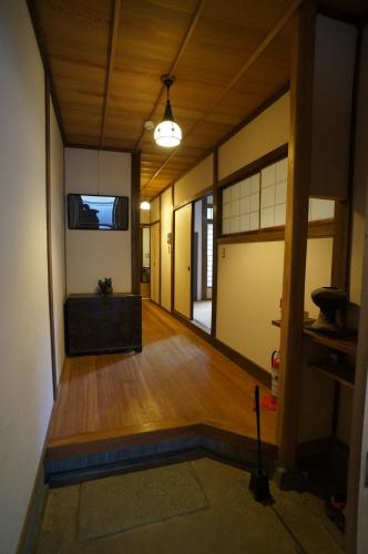 an empty room with a wooden floor and a hallway at Mujinzo in Yufuin