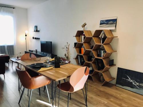 a dining room with a wooden table and chairs at Home Sweet Home in Cognac