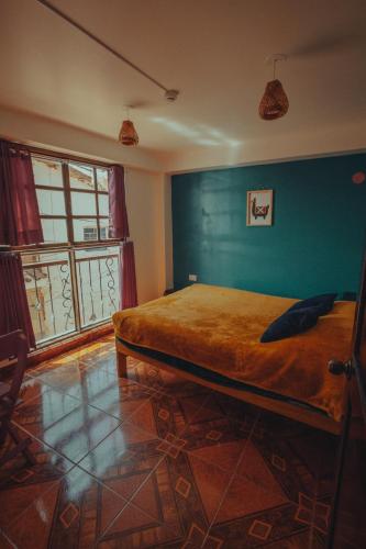a bedroom with a bed and a green wall at The Chusay Rooftop in Cusco