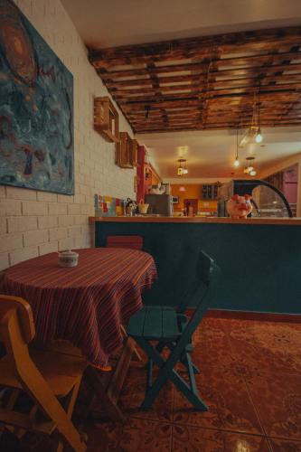 a table in a kitchen with a table and a chair at The Chusay Rooftop in Cusco