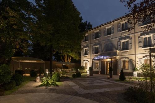 a large white building with a courtyard at night at Villa Petra in Novellara
