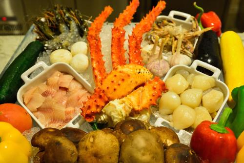 a tray of seafood and vegetables on a table at Orient-Anyi international Hotel in Beijing