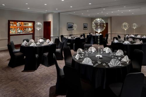 a conference room with tables and chairs with glasses on them at Holiday Inn Hull Marina by IHG in Hull