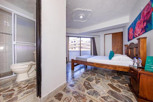 a bedroom with a bed and a toilet at Ayenda 1228 Balcones de la 70 in Medellín