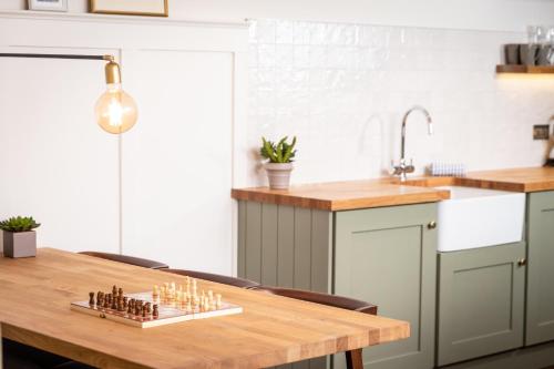 a kitchen with a wooden table with candles on it at Galgorm in Ballymena