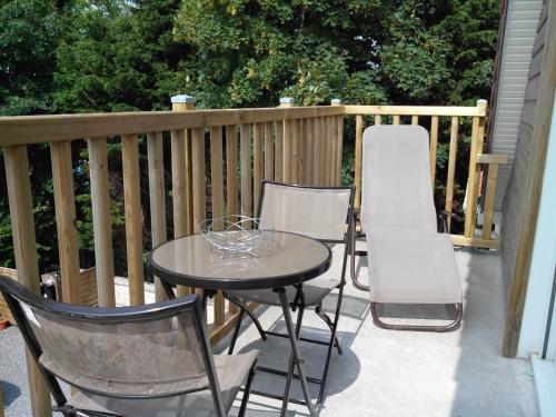 a patio with a table and chairs and a mattress at La marine D'opale in Ambleteuse