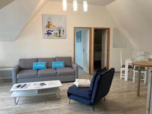 a living room with a couch and a table at La marine D'opale in Ambleteuse