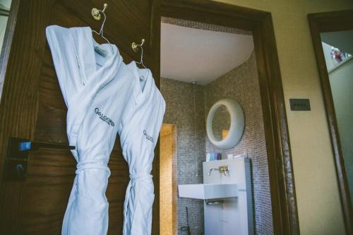 a white jacket hanging on a wall next to a refrigerator at Galgorm in Ballymena