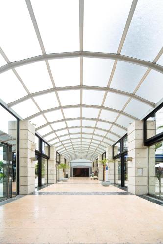 an empty building with a large glass ceiling at The Residential Suites Fukuoka in Fukuoka