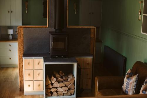 a wood stove in a living room with a fireplace at Galgorm in Ballymena