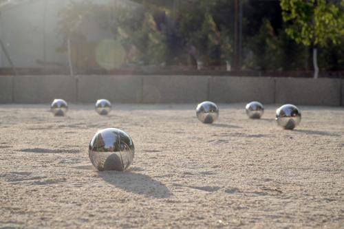 a group of silver balls in the sand at Sami Beach Hotel in Sami