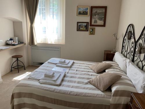 a bedroom with a large bed with towels on it at Balbianino in Lenno