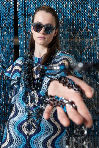 a woman wearing sunglasses holding a pair of scissors at Linder Cycling Hotel in Selva di Val Gardena