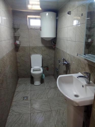 a bathroom with a toilet and a sink at Sheki Guest House in Sheki
