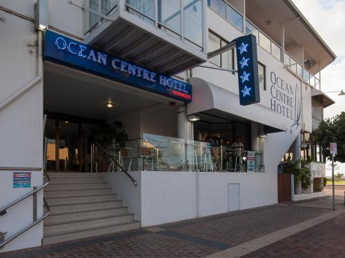 a building with a restaurant and stairs in front of it at Ocean Centre Hotel in Geraldton