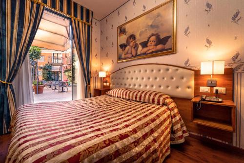 מיטה או מיטות בחדר ב-Hotel Villa Romeo