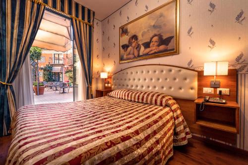 a hotel room with a bed and a window at Hotel Villa Romeo in Catania