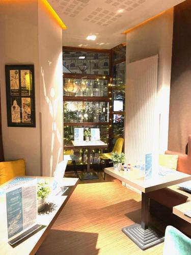 a restaurant with two tables and a dining room at Kyriad Restaurant Centre SPA Vichy in Vichy