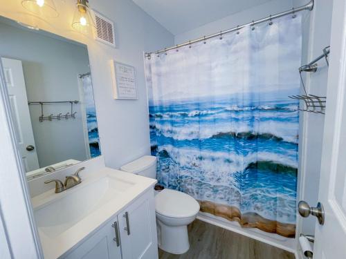a bathroom with a white toilet and a shower curtain at Great Stay in South Florida! -D-Centrally located in Miami