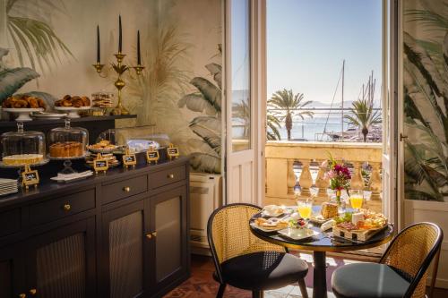 a table with food on it in a room with a window at Birkin Porto 1870 in Cagliari