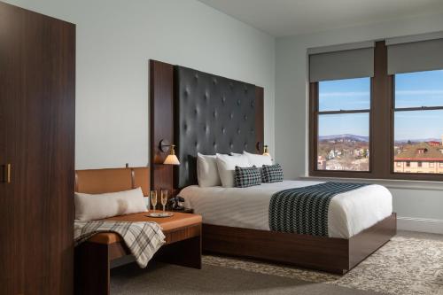 a hotel room with a bed and a window at The Liberty Trust in Roanoke