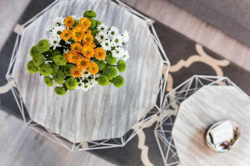 a vase filled with flowers on top of a table at Sopot Pier Apartments by OneApartments in Sopot