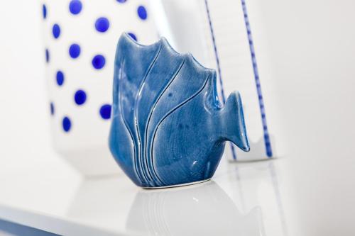 a blue vase sitting on top of a table at Sopot Pier Apartments by OneApartments in Sopot