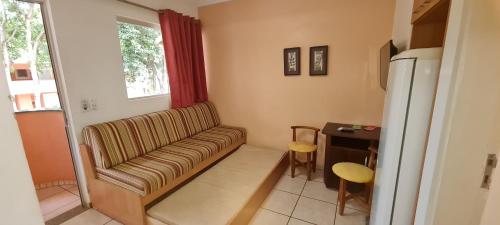 a living room with a couch and a table at diRoma Fiori - Apartamentos JN in Caldas Novas