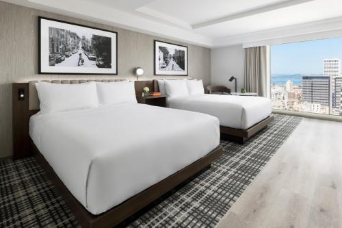 a hotel room with two beds and a large window at Hyatt Regency San Francisco Downtown SOMA in San Francisco