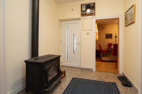 a living room with a black stove in a room at Apartman JOZIC in Knin