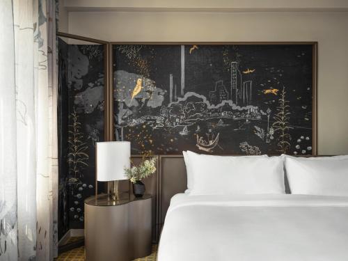 a bed with a painting on the wall and a painting on the wall at Park Lane New York in New York