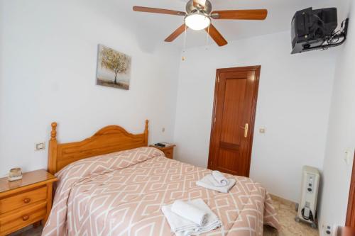 a bedroom with a bed and a ceiling fan at San Antón in Cazorla