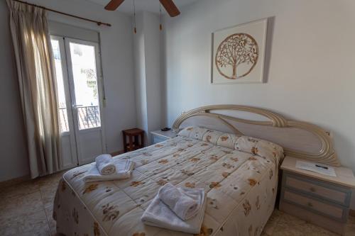 a bedroom with a bed with towels on it at San Antón in Cazorla
