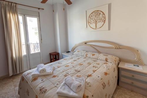 a bedroom with a bed with towels on it at San Antón in Cazorla